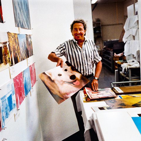 Robert Rauschenberg holds an image of a dog while working on the prototypes of 'Tibetan Keys and Locks' at Gemini G.E.L., the publisher, artists' workshop and gallery. © 1986 Sidney B. Felsen